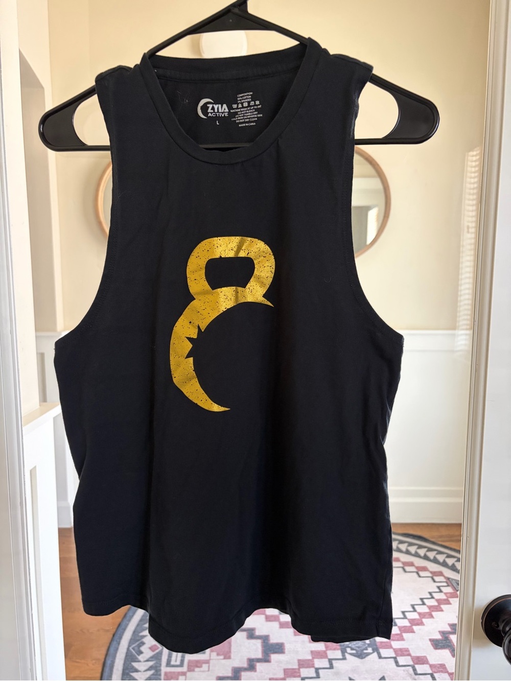 ZYIA Black Muscle Tank with Gold Kettlebell Crescent Graphic